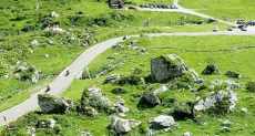 Motorcycle tour on the winding road to Sella pass, Dolomites